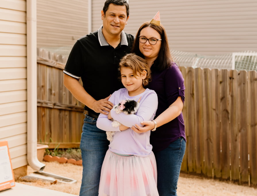 Happy family with their puppy from Puppy Palace